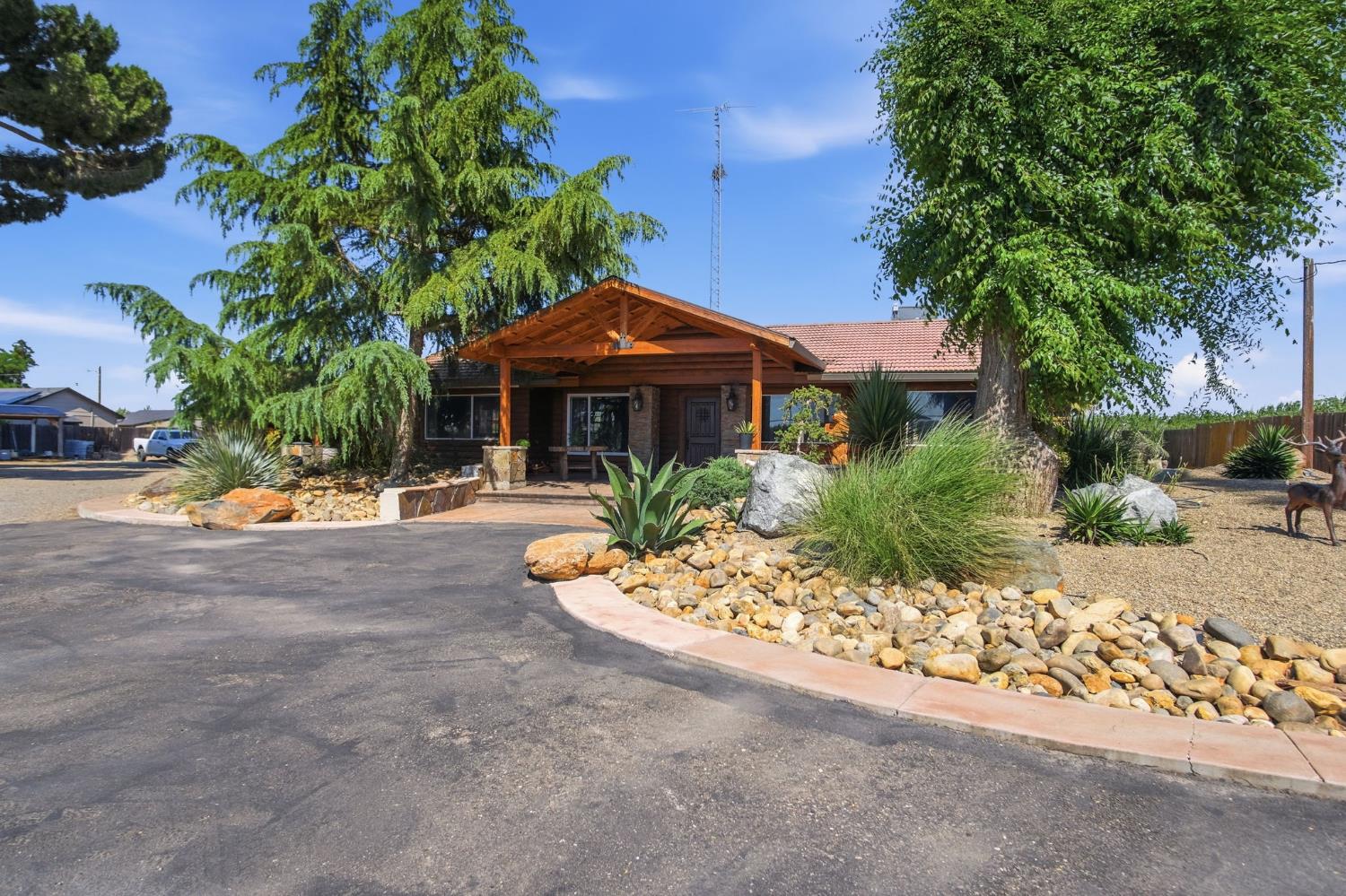 5200 North Gratton Road Denair, CA 95316 - Photo 3 of 40 a front view of a house with a yard and large tree