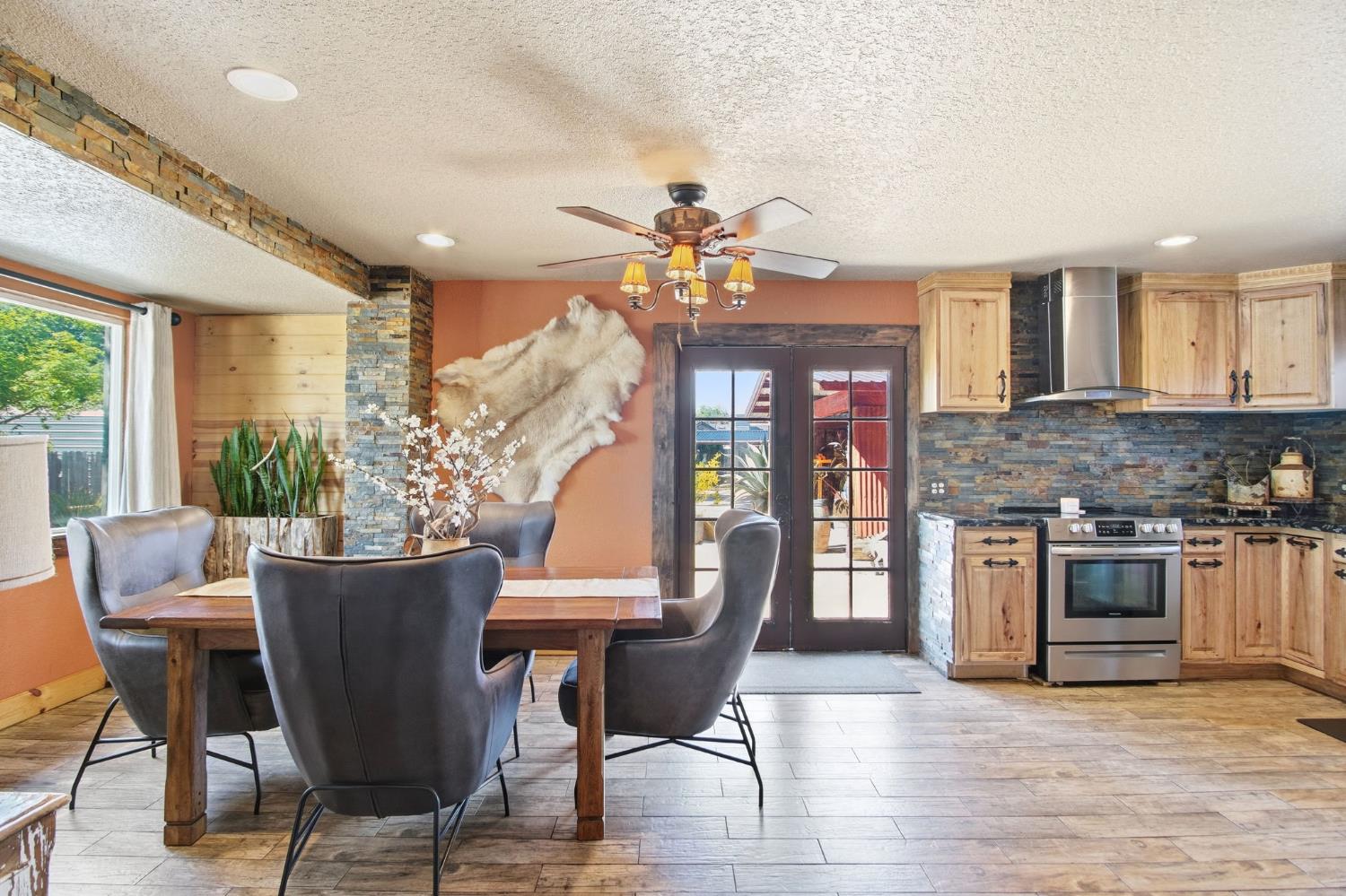 5200 North Gratton Road Denair, CA 95316 - Photo 9 of 40 a view of a dining room with furniture a chandelier and wooden floor