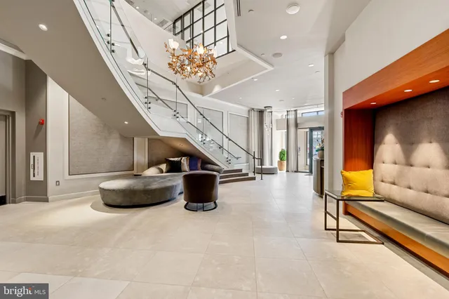 a large white kitchen with lots of counter top space and stainless steel appliances