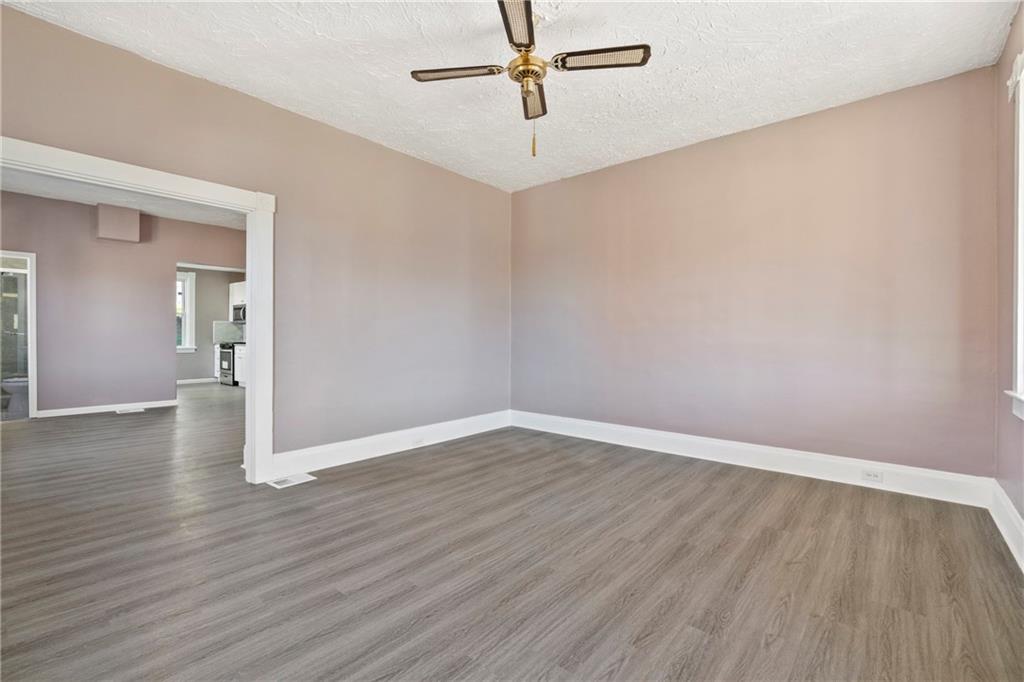 711 9th Avenue Irwin, PA 15642 - Photo 8 of 26 a view of an empty room with wooden floor