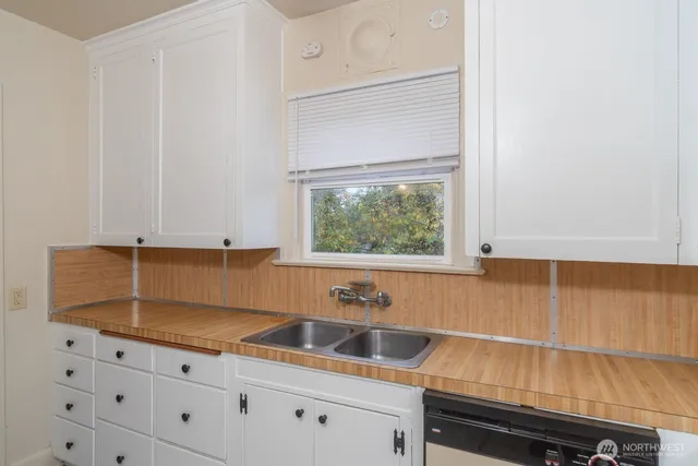 a kitchen with a sink and cabinets