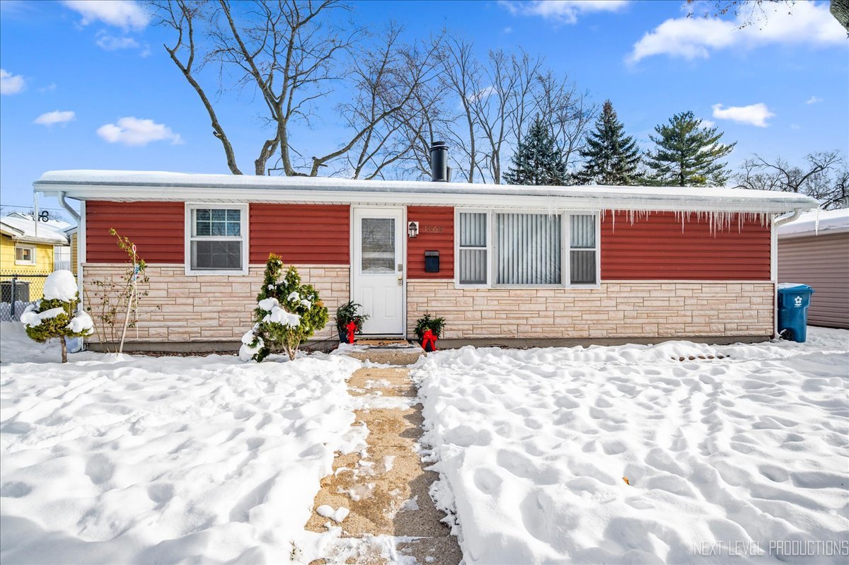 1009 Assell Avenue Aurora, IL 60505 - Photo 1 of 24 a front view of a house with a yard and garage