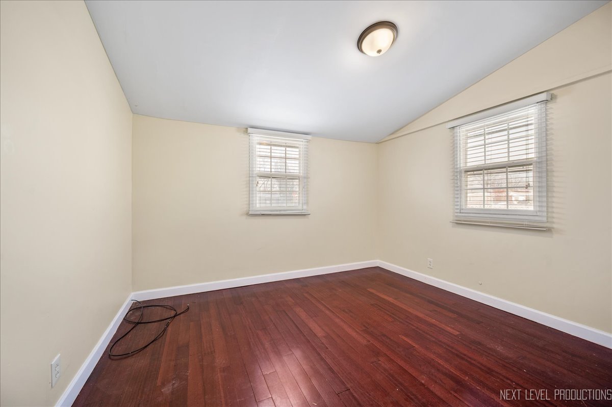 1009 Assell Avenue Aurora, IL 60505 - Photo 11 of 24 an empty room with wooden floor and windows