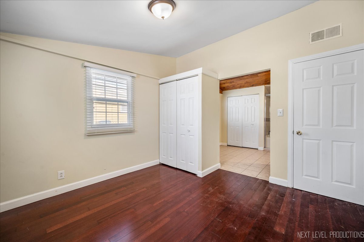 1009 Assell Avenue Aurora, IL 60505 - Photo 12 of 24 an empty room with wooden floor and windows