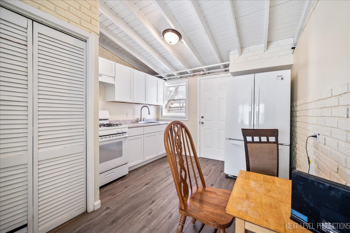 1009 Assell Avenue Aurora, IL 60505 - Photo 15 of 24 a kitchen with stainless steel appliances granite countertop a refrigerator and a stove top oven