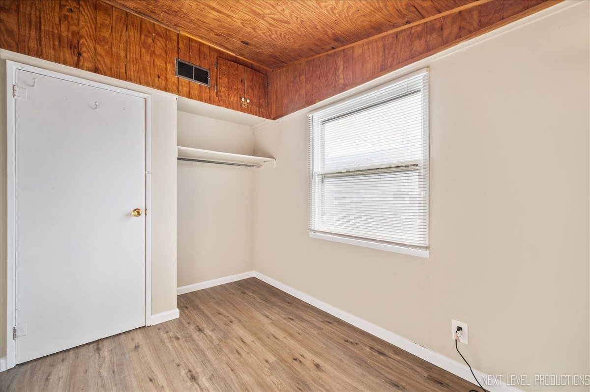 1009 Assell Avenue Aurora, IL 60505 - Photo 5 of 24 a view of an empty room with wooden floor and a window