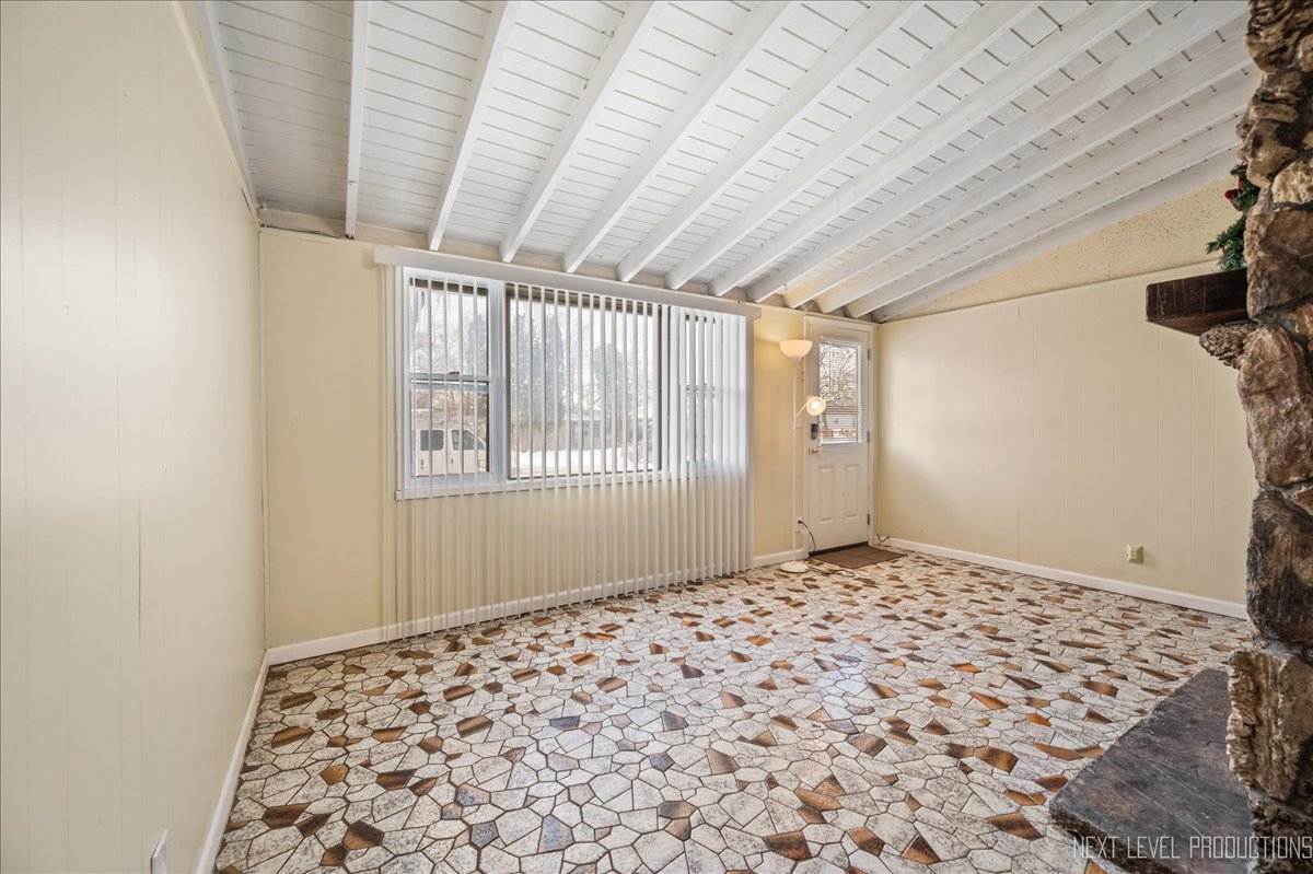 1009 Assell Avenue Aurora, IL 60505 - Photo 9 of 24 a bedroom with a bed and a window