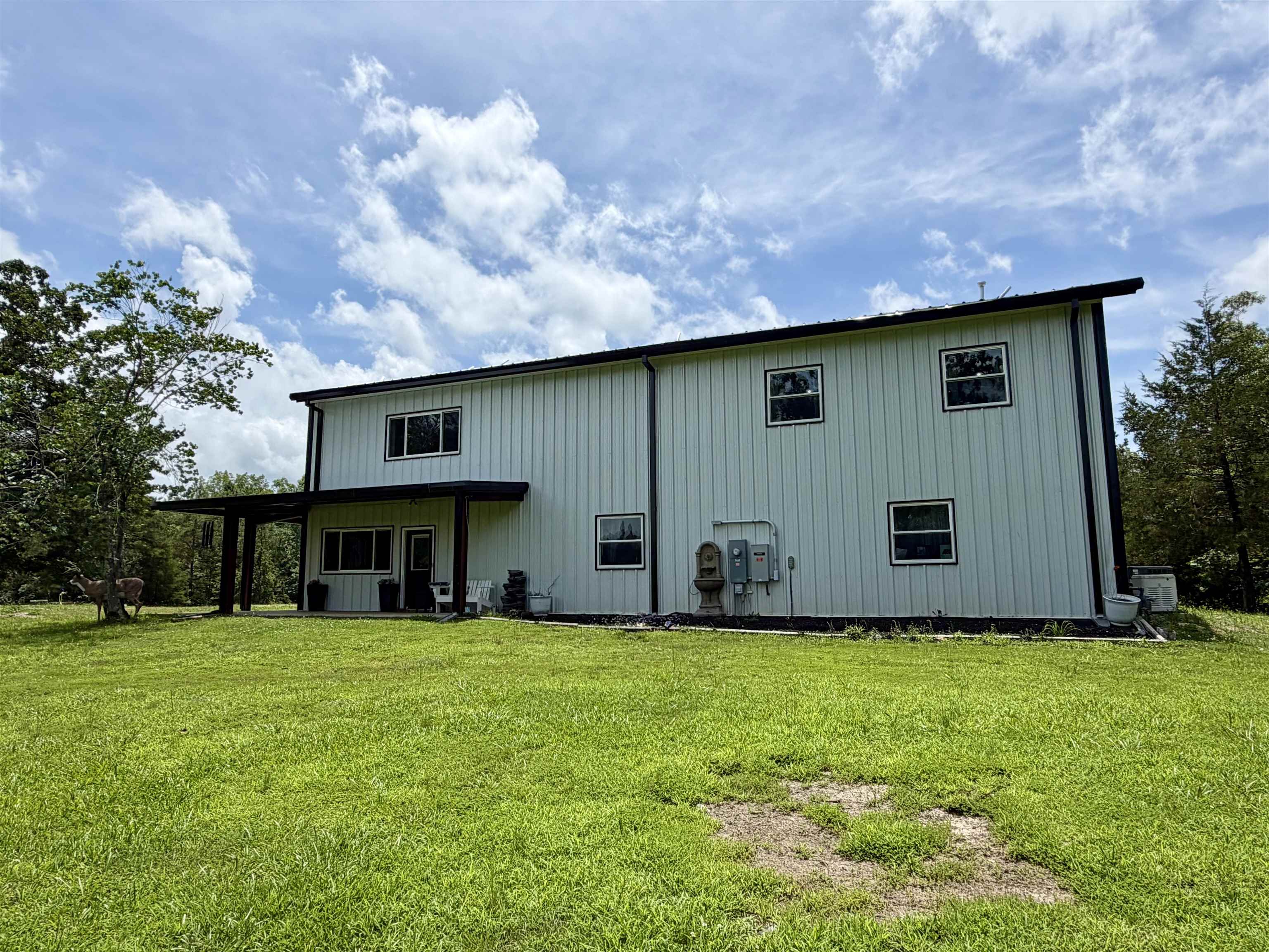3670 Peavine Road Middleton, TN 38052 - Photo 35 of 36 Two-story residence featuring vertical siding, dark trim, and multiple windows