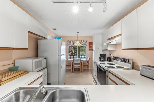 a kitchen that has a refrigerator and a stove