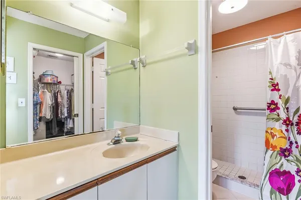 a bathroom with a sink vanity and a mirror