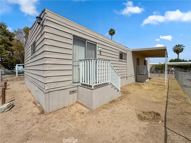 a view of a house with backyard and deck