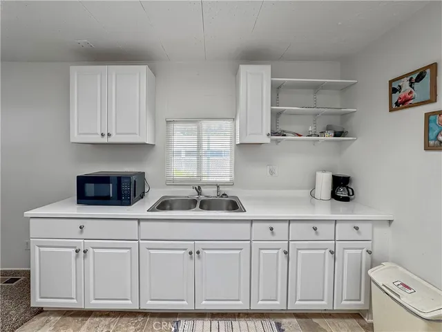 a kitchen with white cabinets and white appliances