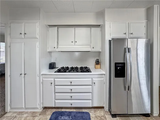 a kitchen with stainless steel appliances a refrigerator and cabinets