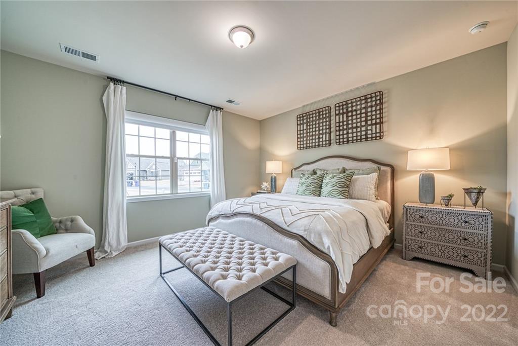 3196 Windhaven Lane, Unit 112 Tega Cay, SC 29708 - Photo 18 of 26 a bedroom with a bed and a window