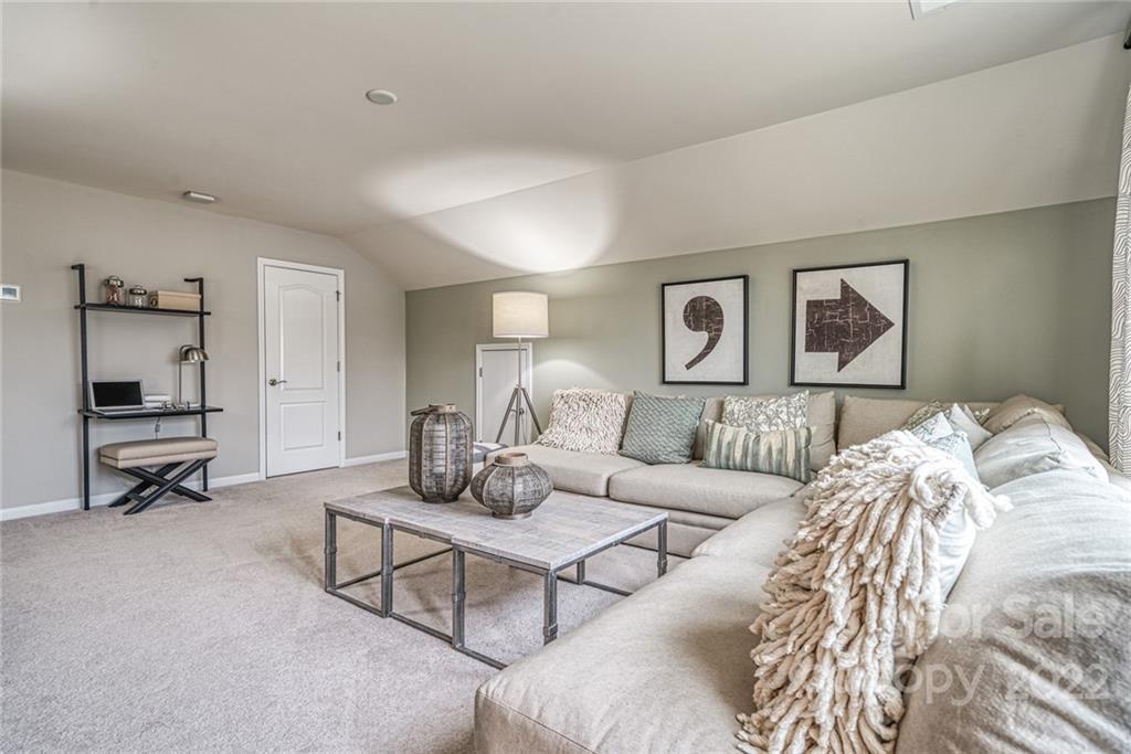 3196 Windhaven Lane, Unit 112 Tega Cay, SC 29708 - Photo 23 of 26 a living room with furniture and a lamp