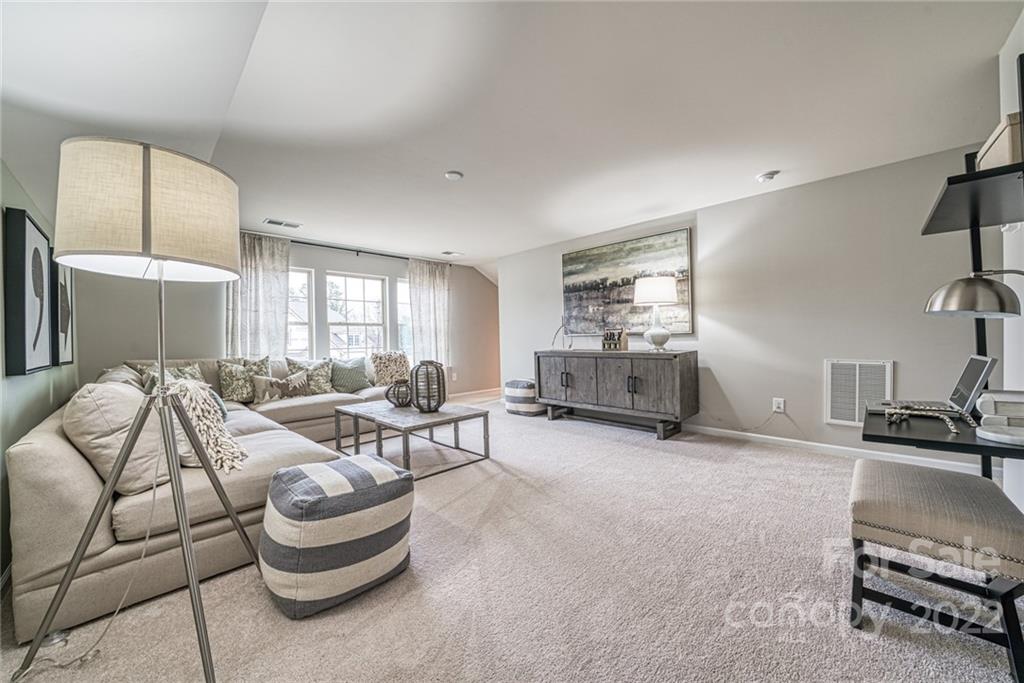 3196 Windhaven Lane, Unit 112 Tega Cay, SC 29708 - Photo 24 of 26 a living room with furniture and a large window