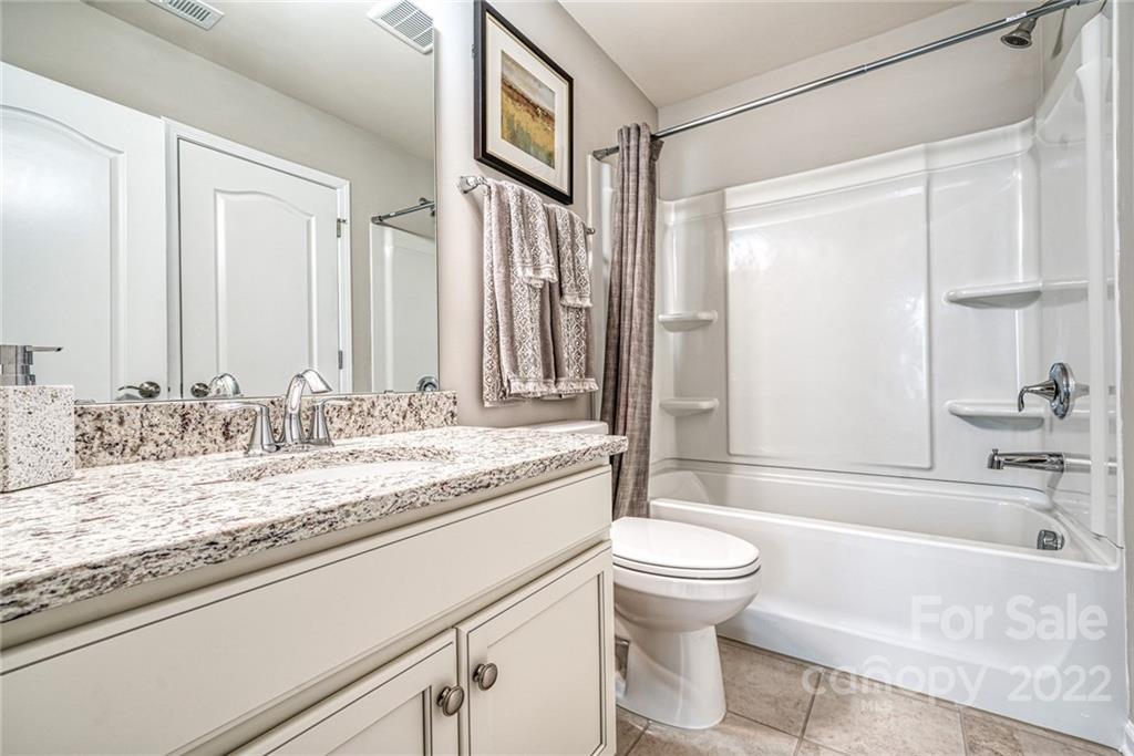 3196 Windhaven Lane, Unit 112 Tega Cay, SC 29708 - Photo 26 of 26 a bathroom with a granite countertop sink toilet and shower