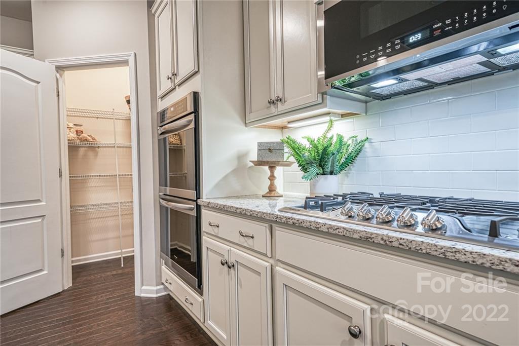 3196 Windhaven Lane, Unit 112 Tega Cay, SC 29708 - Photo 9 of 26 a kitchen with stainless steel appliances granite countertop a refrigerator and a sink