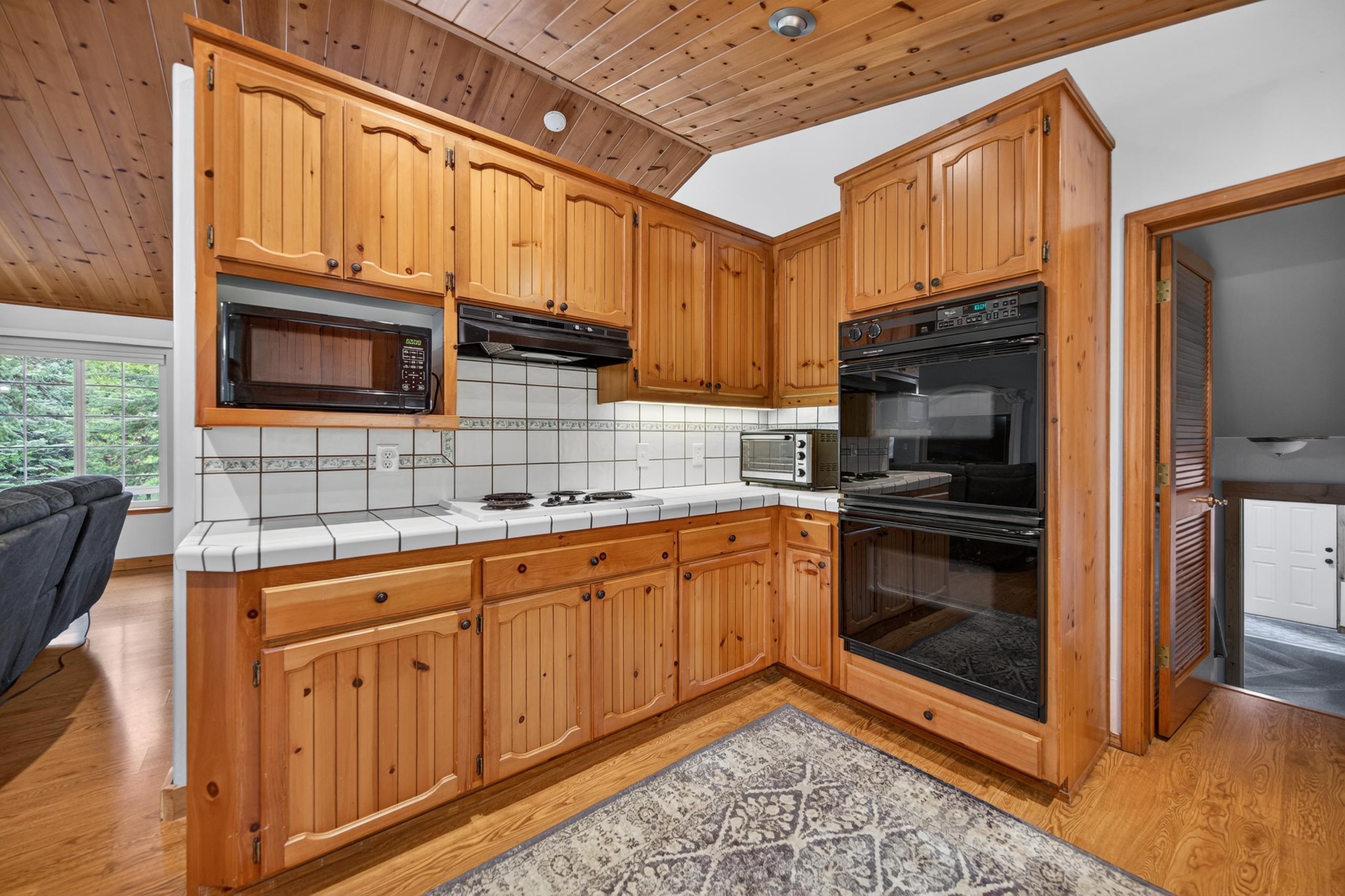 1220 Lynx Road Lake Almanor, CA 96137 - Photo 18 of 45 a kitchen with stainless steel appliances granite countertop a stove microwave and refrigerator