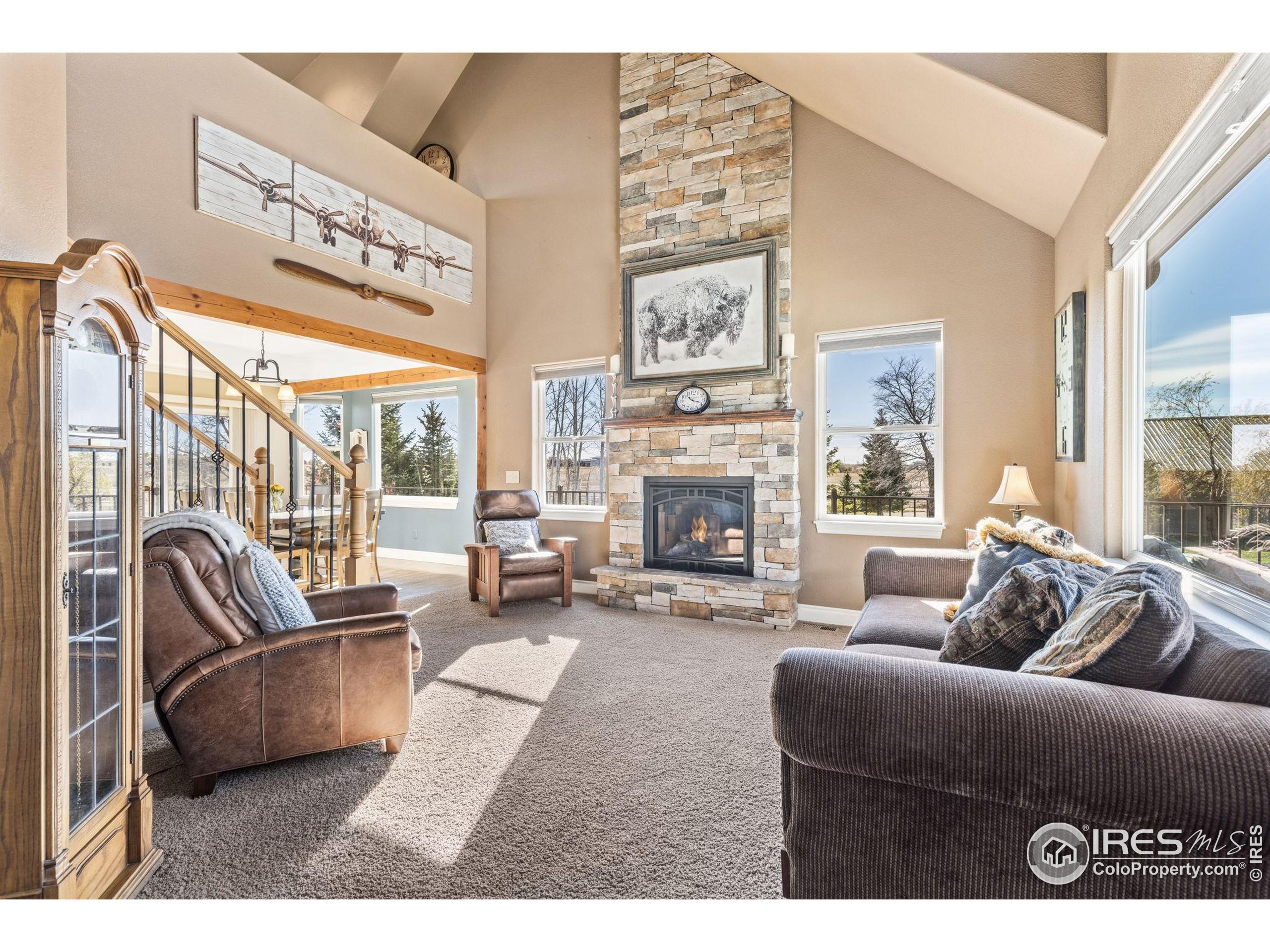 1822 Quarter Lane Berthoud, CO 80513 - Photo 12 of 49 a living room with furniture a large window and a fireplace