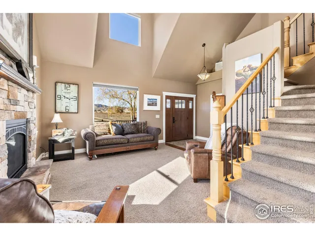 a kitchen with stainless steel appliances granite countertop a refrigerator a oven a sink dishwasher and white cabinets with wooden floor