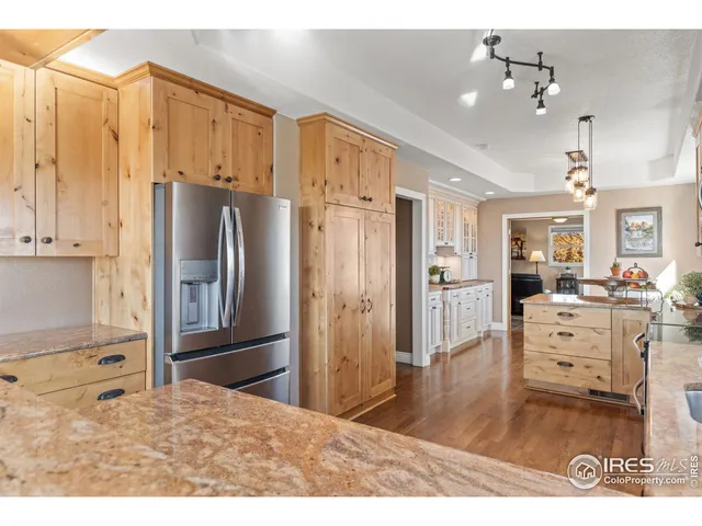 a kitchen with granite countertop a white cabinets and sink