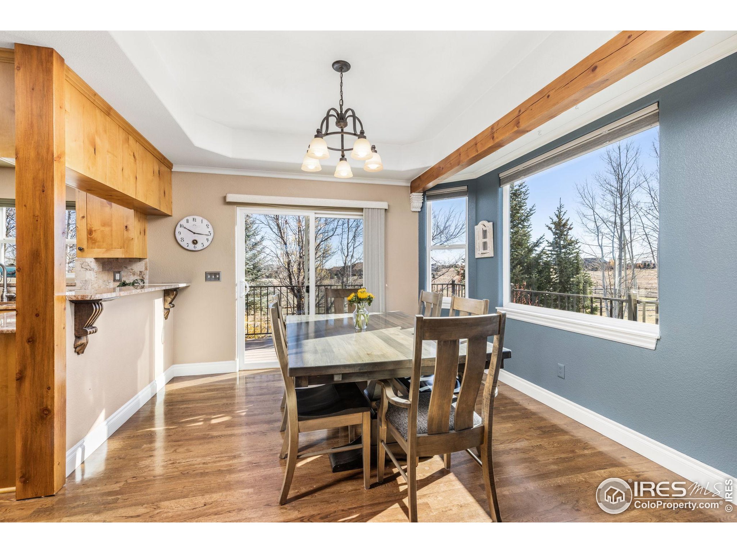 1822 Quarter Lane Berthoud, CO 80513 - Photo 17 of 49 a view of a dining room with furniture wooden floor and chandelier