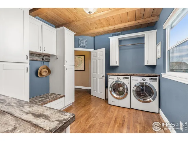 a spacious bedroom with a bed and a chandelier