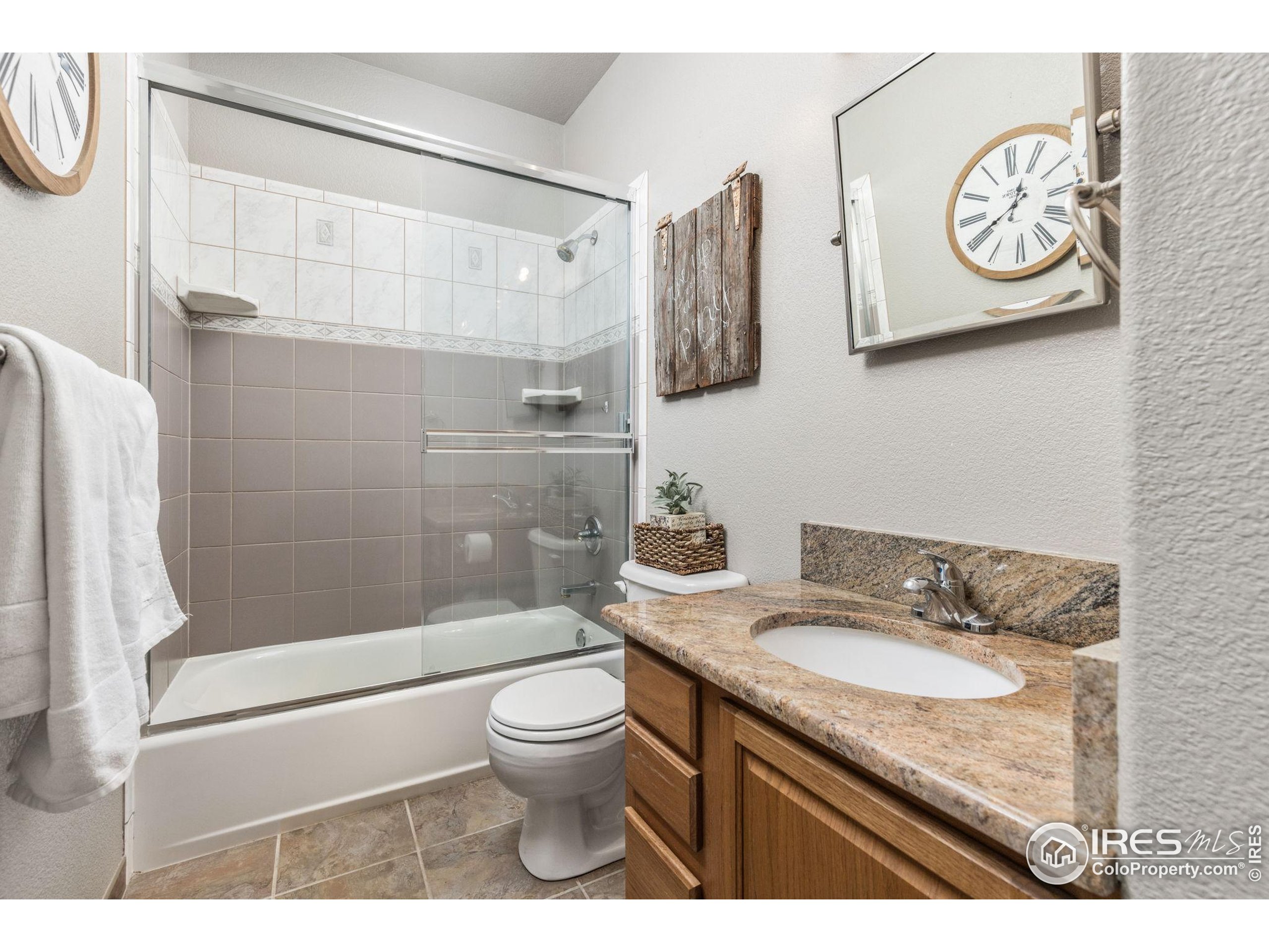 1822 Quarter Lane Berthoud, CO 80513 - Photo 22 of 49 a bathroom with a granite countertop sink toilet and shower