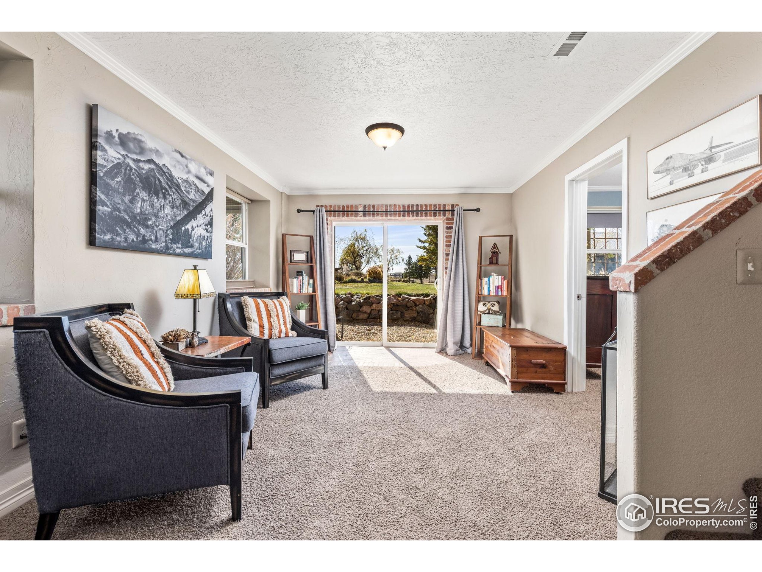 1822 Quarter Lane Berthoud, CO 80513 - Photo 30 of 49 a living room with furniture and a large window