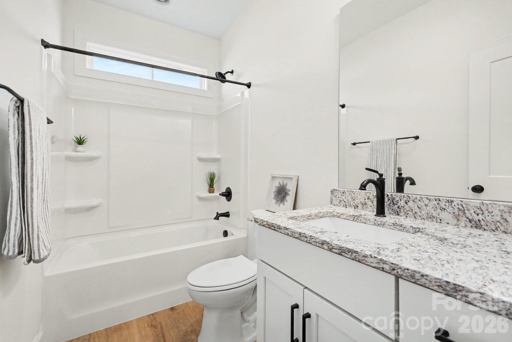 190 Goodnight Road Salisbury, NC 28147 - Photo 25 of 35 a bathroom with a granite countertop sink a toilet and bathtub