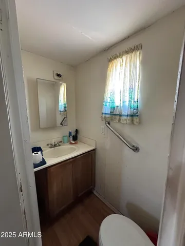 a bathroom with a toilet sink and mirror