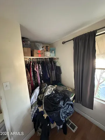 a bed sitting in a bedroom next to a window