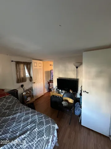 a bedroom with a bed couch and a window