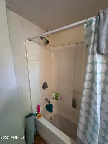 a bathroom with a shower and a bathtub
