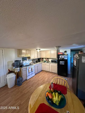 a living room with furniture and kitchen view
