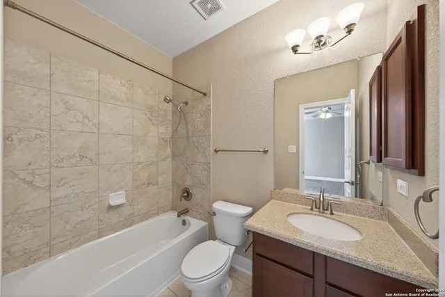 a bathroom with a sink a toilet a mirror a bathtub and shower