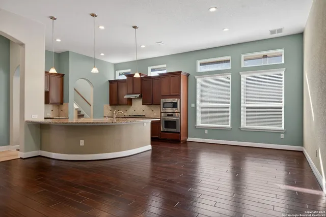 a view of kitchen with cabinets and wooden floor