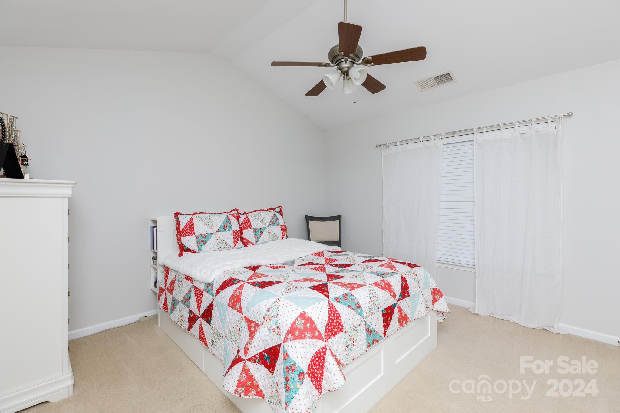 3051 Summerfield Ridge Lane Matthews, NC 28105 - Photo 11 of 23 a bedroom with a bed and a chandelier