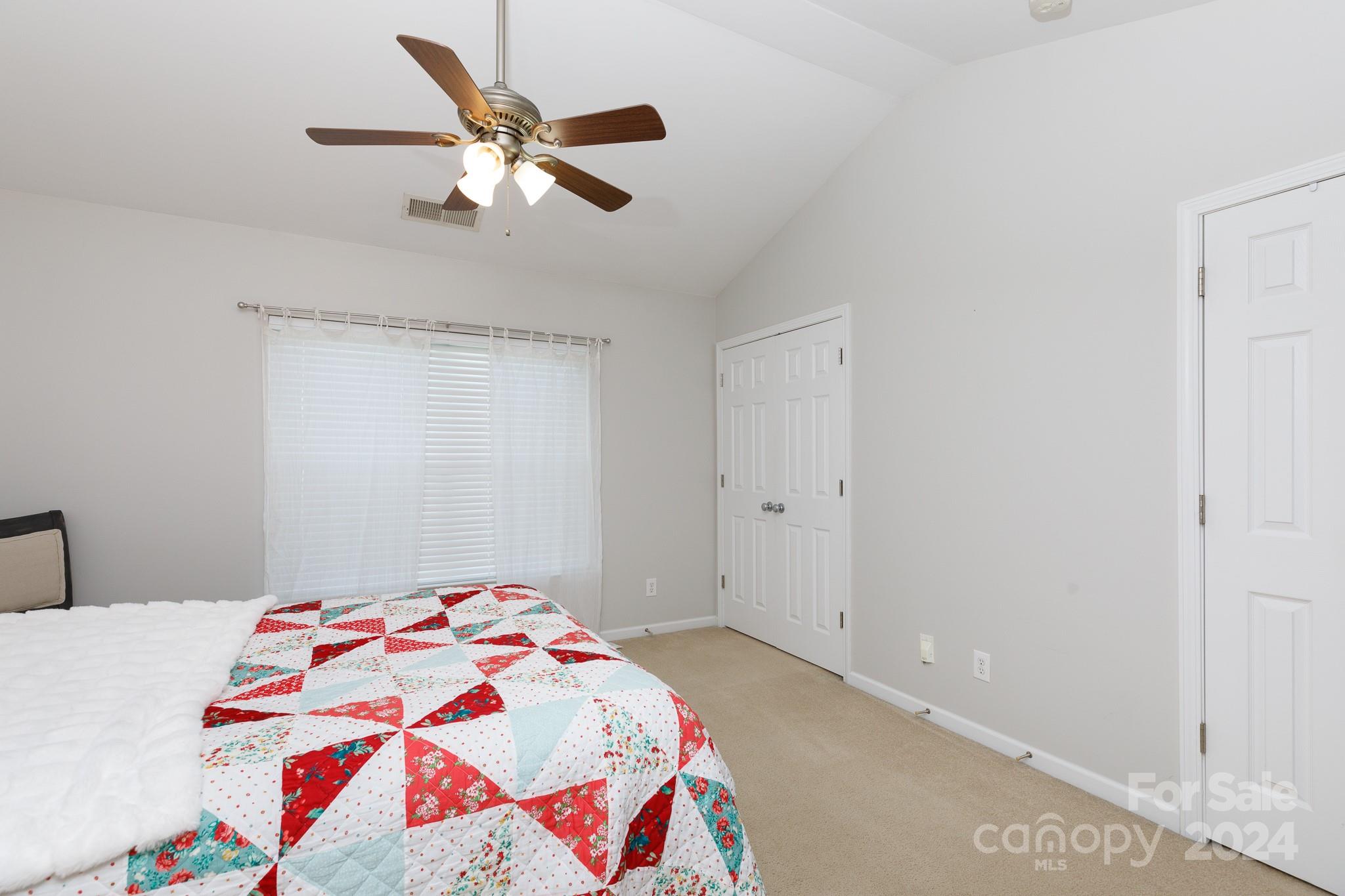 3051 Summerfield Ridge Lane Matthews, NC 28105 - Photo 13 of 23 a bedroom with a bed and a chandelier