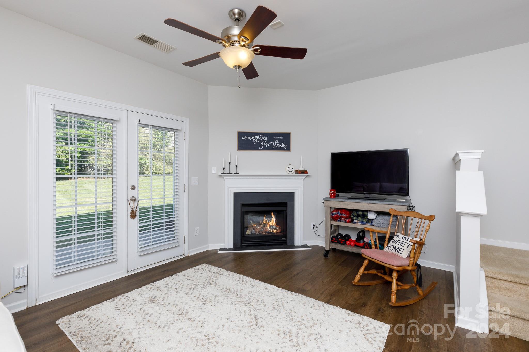 3051 Summerfield Ridge Lane Matthews, NC 28105 - Photo 3 of 23 a living room with furniture a flat screen tv and a fireplace