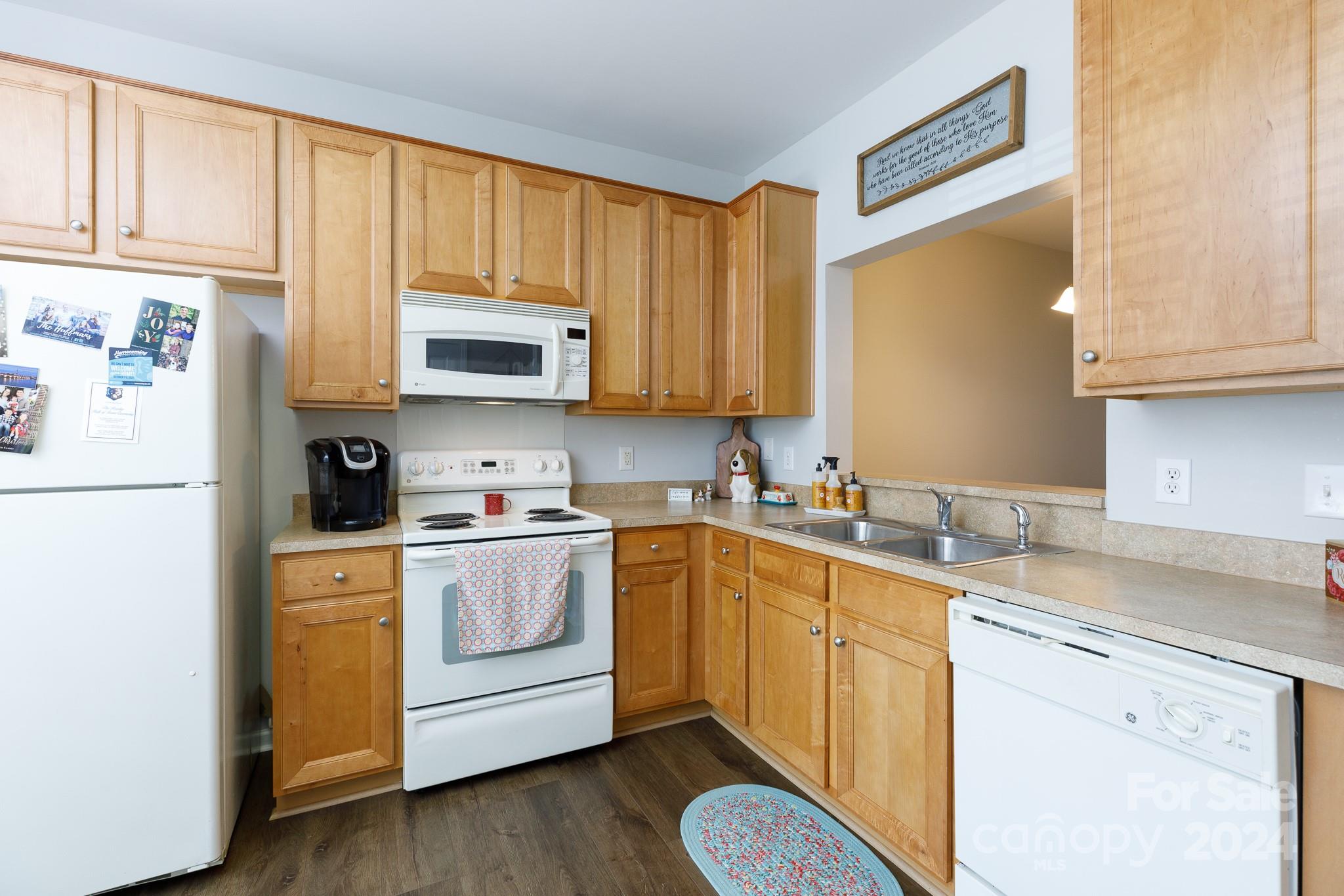 3051 Summerfield Ridge Lane Matthews, NC 28105 - Photo 7 of 23 a kitchen with stainless steel appliances granite countertop a sink a stove a refrigerator with grey cabinets