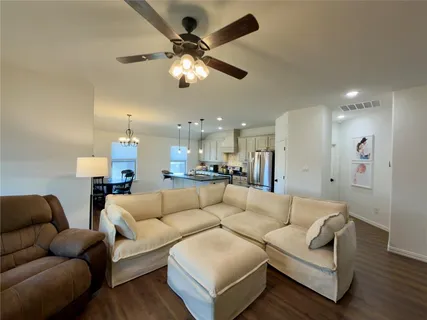 a living room with furniture and a chandelier
