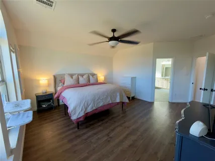 a bedroom with bed and window