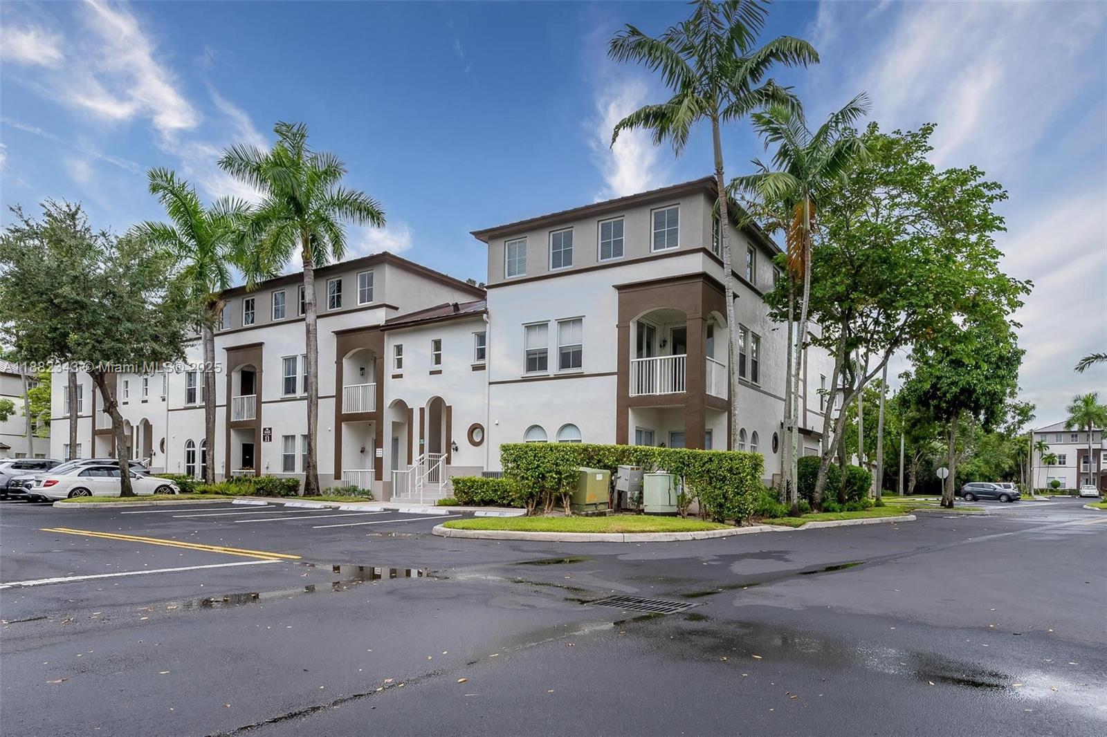 4455 Southwest 160th Avenue, Unit 205 Miramar, FL 33027 - Photo 1 of 44 a front view of a house with a yard and garage
