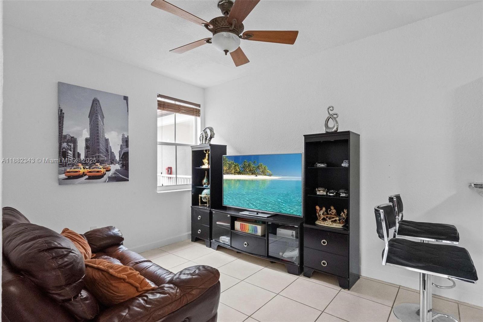 4455 Southwest 160th Avenue, Unit 205 Miramar, FL 33027 - Photo 11 of 44 a living room with furniture and a flat screen tv