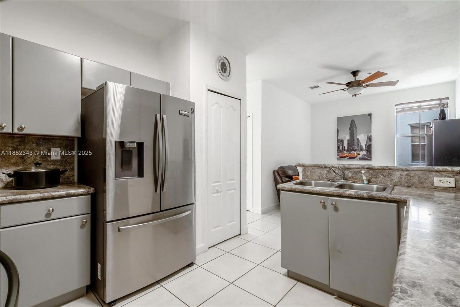 4455 Southwest 160th Avenue, Unit 205 Miramar, FL 33027 - Photo 15 of 44 a kitchen with stainless steel appliances granite countertop a refrigerator a stove a sink and a refrigerator
