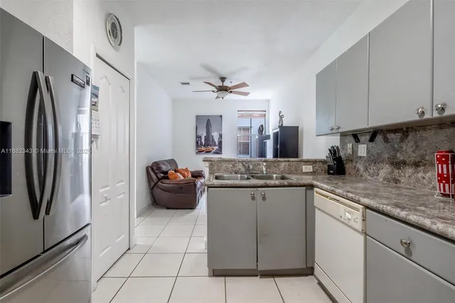 a kitchen with stainless steel appliances a sink stove and refrigerator