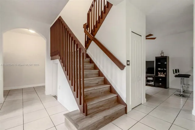 wooden floor with white walls and stairs