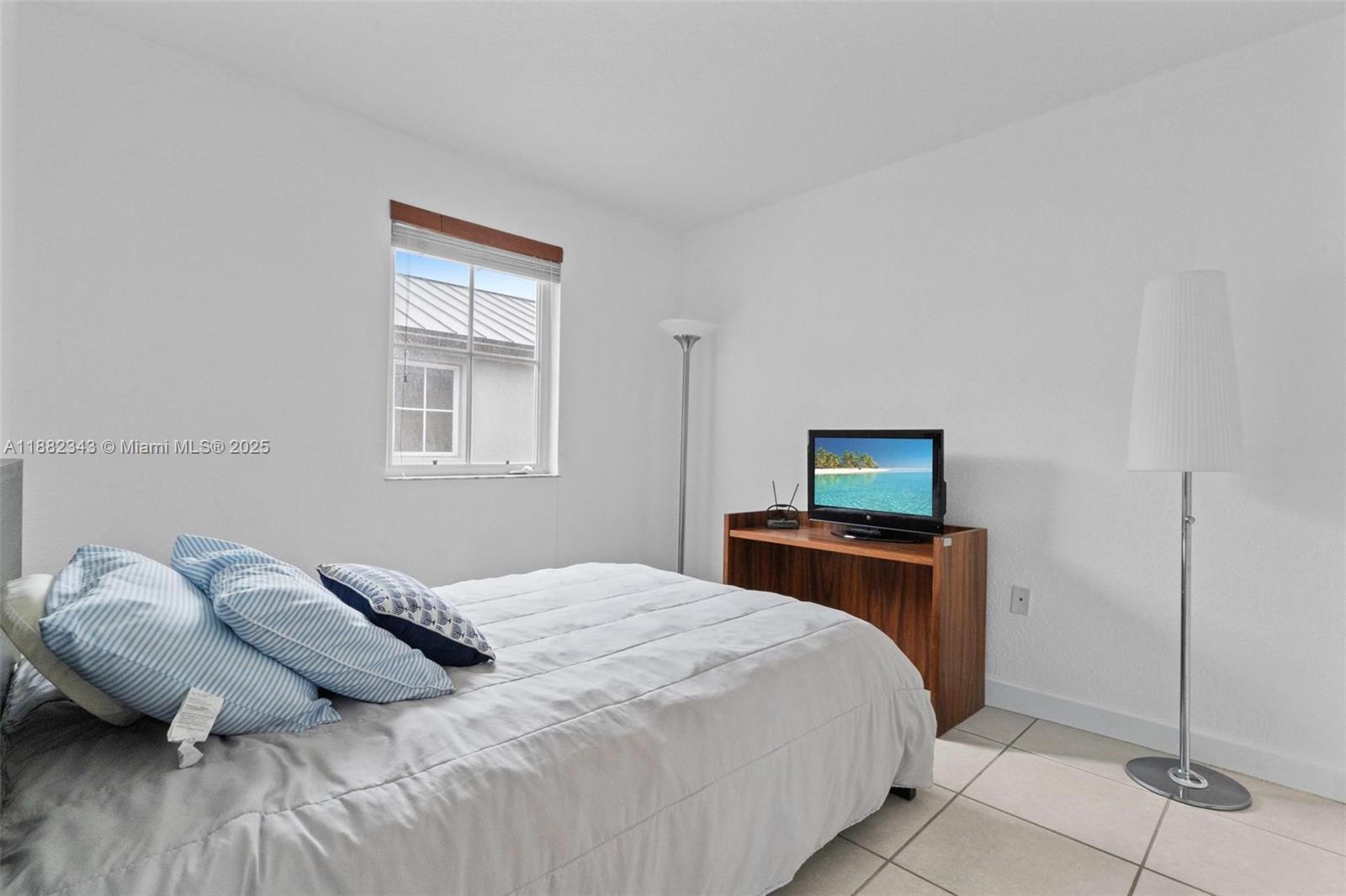 4455 Southwest 160th Avenue, Unit 205 Miramar, FL 33027 - Photo 20 of 44 a bedroom with a bed and window